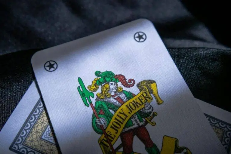 Detailed shot of a Jolly Joker playing card with intricate design in a low light setting.