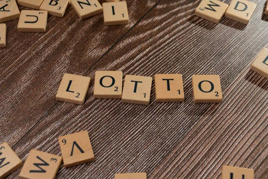 Scrabble tiles spelling 'LOTTO' on a wooden table surface, symbolizing chance and gaming.