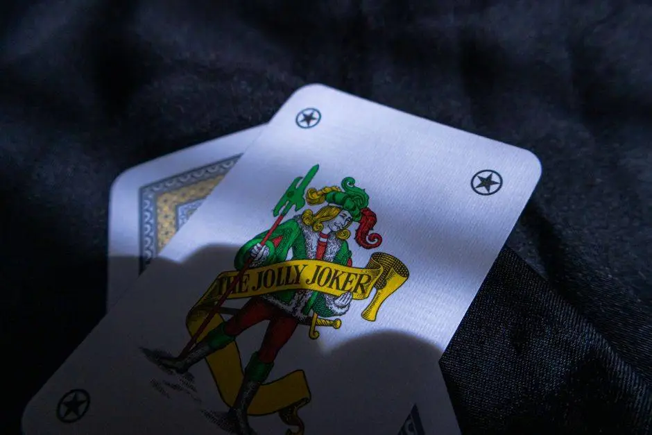 A detailed image of a Joker playing card casting a shadow on a dark surface.